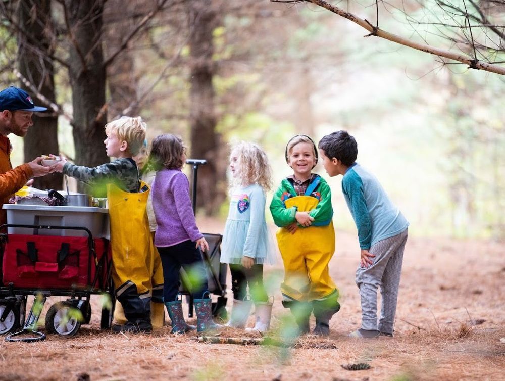 Students line up for a snack during a busy day outdoors at the Kickapoo Valley Forest School.